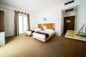 Postel nebo postele na pokoji v ubytování Hotel Trieste