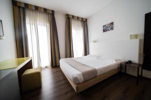 Postel nebo postele na pokoji v ubytování Hotel Trieste