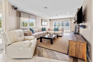 a living room with a couch and a table at Hamptons Waterfront - Shinnecock Bay in Hampton Bays