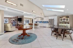a kitchen and dining room with a table and chairs at Hamptons Waterfront - Shinnecock Bay in Hampton Bays