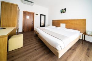 Postel nebo postele na pokoji v ubytování Hotel Trieste