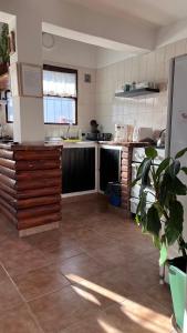 a large kitchen with a counter and a counter top at La Casita de Lorena in El Bolsón
