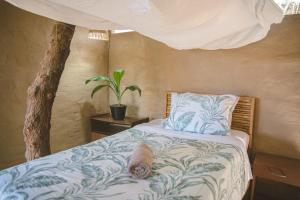 a bedroom with a bed with a plant on it at AguaMar Vichayito in Vichayito +98 photos