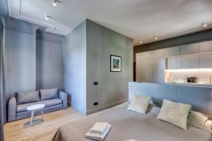 a living room with a bed and a couch at Apartments Vitenberg in Cēsis