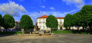 a large building with a fountain in front of it at Flat Accommodation in Braga in Braga