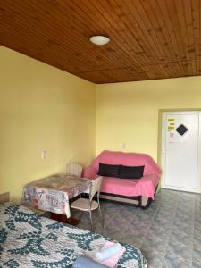 a room with a pink bed and a table at Dejan apartment 3-Free parking near Arena in city center, near bus, train, ferry, airport shuttle in Pula