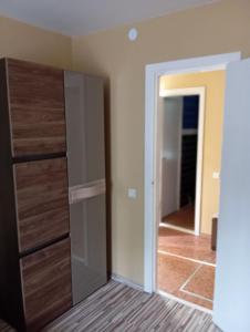 a room with a closet with wooden doors and a hallway at Летний дом у моря in Jūrmala +14 photos