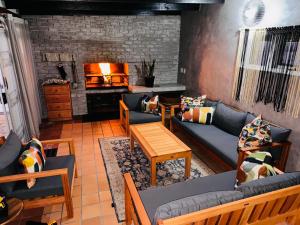 a living room with a couch and a fireplace at LazyYzer in Yzerfontein