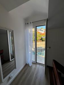 a room with a mirror and a sliding glass door at Home Away From Home in Funchal