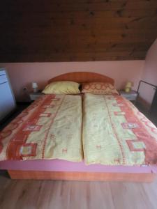 a large bed in a room with two tables at Rooms MARETČ in Bohinj