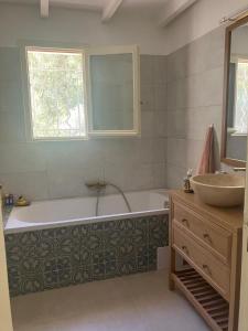 a bathroom with a bath tub and a sink at Villa Paradis des Oréades in Lauris +48 photos