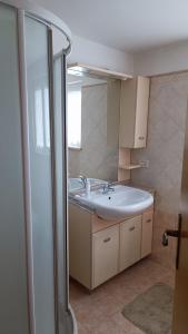 a bathroom with a sink and a shower at APPARTAMENTO PAMELA b&b in Grado +36 photos