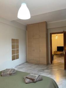 a bedroom with a bed and a living room at Maria's central apartment in Xanthi