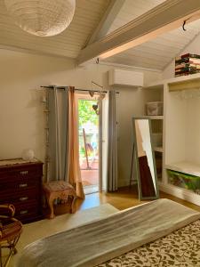 a bedroom with a bed and a dresser and a window at Casa do Paço Aveiro HolidayHome in Aveiro