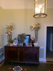 a room with a table with flowers on it at Lisglassock House in Longford +39 photos