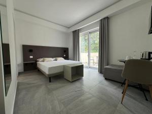 a bedroom with a bed and a large window at Villa Mimosa Florital - Free Private Parking On site & in Tropea in Santa Domenica