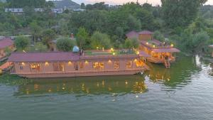 a large boat in the water with lights on it at Peacock Houseboats in Srinagar