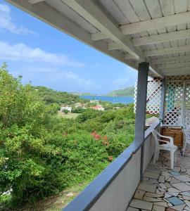 a balcony with a view of the ocean at Chocolate apartment in English Harbour Town