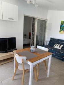 a living room with a table and a couch at L'Eden in Ansouis