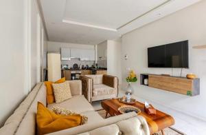 a living room with a couch and a tv at Atlantic Suite View 1 in Casablanca