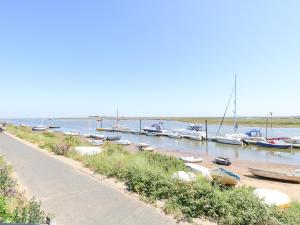 a bunch of boats are docked in the water at Crab Corner in Wells next the Sea