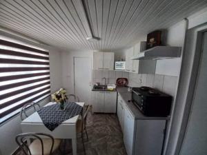 a small kitchen with a table and a small table and a tableablish at Zvezda in Kladovo