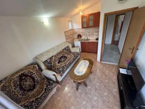 a living room with a couch and a table at Apartmani Joca in Sutomore