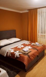 a bedroom with a bed with flowers on it at Apartman Tina in Zagreb