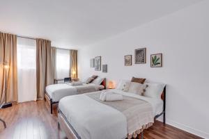 Postel nebo postele na pokoji v ubytování Condo 201 - District Branché St-Roch