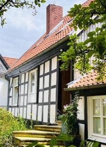 a black and white house with a brick roof at Lateinschule in Tecklenburg