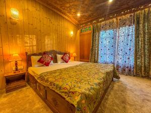 a bedroom with a large bed in a room at Peacock Houseboats in Srinagar