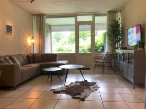 a living room with a couch and a table at De Tureluur Bruinisse in Bruinisse