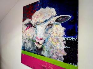 a painting of a sheep with flowers in its mouth at Casa Bella Holiday Home Rab in Rab