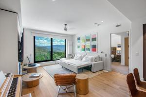 a living room with a white couch and a large window at Electric Pass Lodge by Snowmass Vacations in Snowmass Village +107 photos