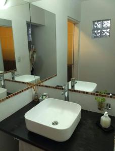 a bathroom with a white sink and a mirror at Mauro y Sonia in Estancia Vieja