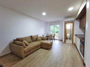 a living room with a couch and a table at Obala Lux Apartman in Sutomore