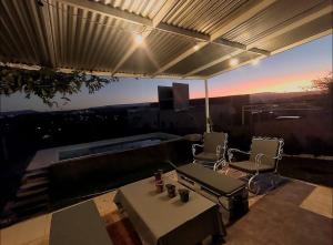 a patio with a pool and two chairs and a table at Mauro y Sonia in Estancia Vieja