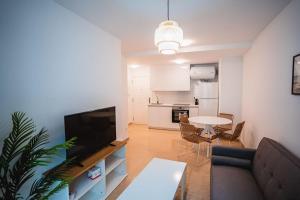 a living room with a couch and a table at Ondas do Mar Boutique Stays - Portonovo 3 in Portonovo