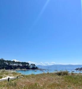 a view of a body of water with boats in it at Ondas do Mar Boutique Stays - Portonovo 3 in Portonovo