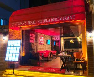 a restaurant with a red sign on the front of it at Ottoman's Pearl Hotel in Istanbul