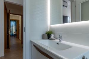 un bagno con un lavandino bianco e uno specchio di Italian Experience-My Florence City Apartment a Firenze Altre 37 foto