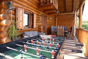 a pool table in the living room of a log cabin at Holiday Home Vinola in Sveti Martin na Muri