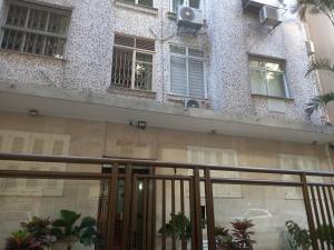 a building with a balcony and a building with windows at SUH Copacabana 19 Spacious Near The Beach! in Rio de Janeiro