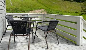 two chairs and a table on a porch at Hytte Nr 2 in Selje