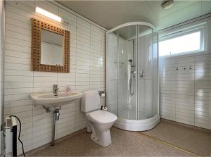 a bathroom with a shower and a toilet and a sink at Hytte Nr 2 in Selje