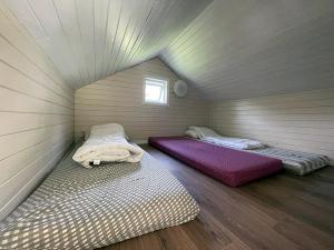 two beds in a room in a attic at Hytte Nr 2 in Selje