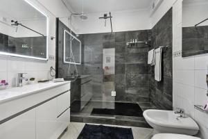 a bathroom with a shower and a toilet and a sink at Vista Tavira Apartmento in Tavira +48 photos