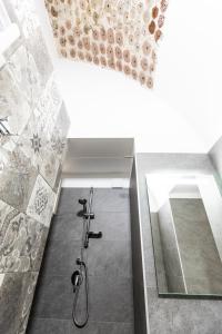 a bathroom with a shower with a glass wall at Villa Ramona in Noicattaro