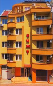 an apartment building with orange and yellow at Hotel Bijou in Burgas