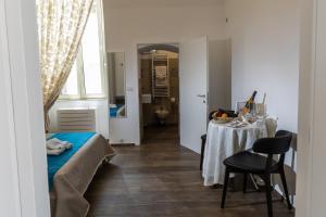 a room with a bed and a table with a chair at Villa Ramona in Noicattaro